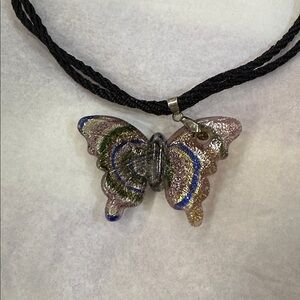 NWT glass butterfly amulet with 24 in long black braid